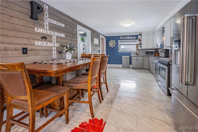 dining space featuring wooden walls