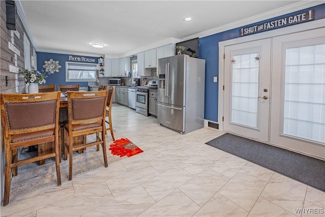 dining area featuring french doors and ornamental molding