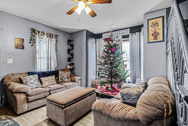 living room featuring ceiling fan, a healthy amount of sunlight, and light wood-type flooring