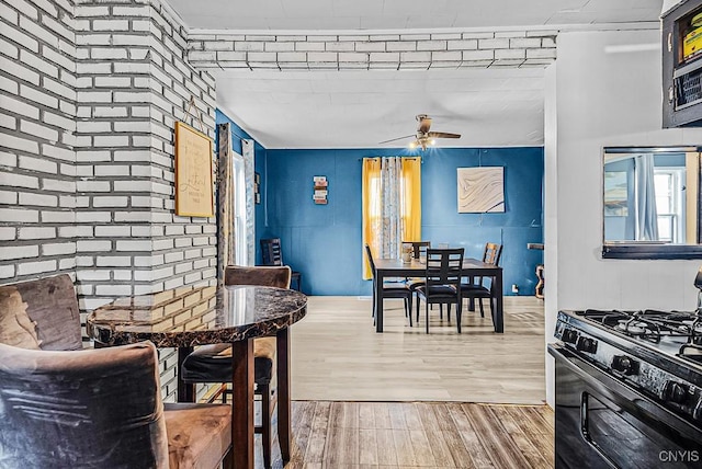 dining room with ceiling fan and wood-type flooring