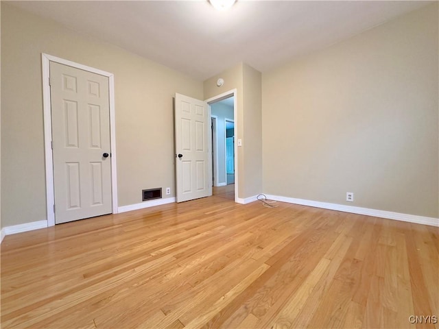 unfurnished bedroom with light wood-type flooring