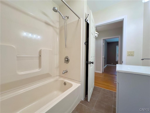 bathroom featuring tile patterned flooring, vanity, and washtub / shower combination