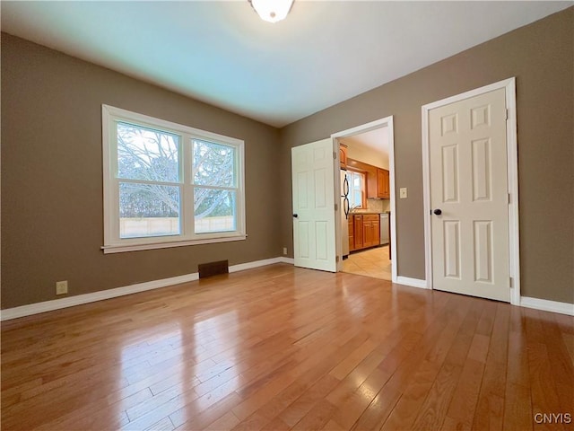 spare room with light hardwood / wood-style flooring