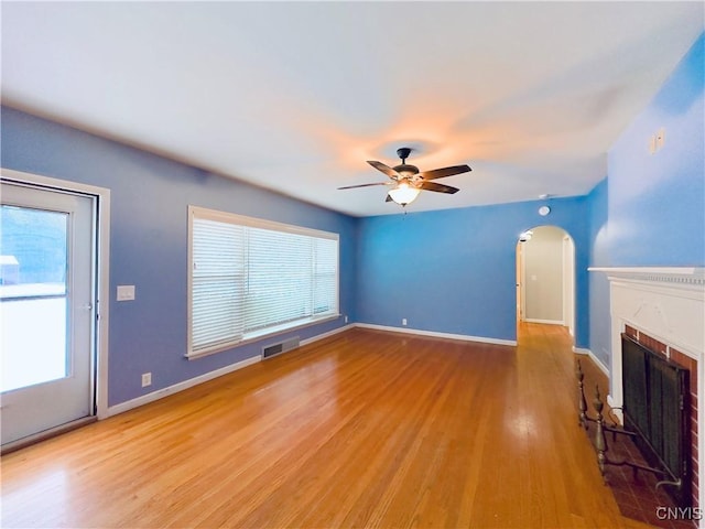 unfurnished living room featuring ceiling fan and light wood-type flooring