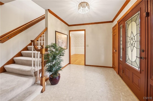 foyer with a notable chandelier and crown molding