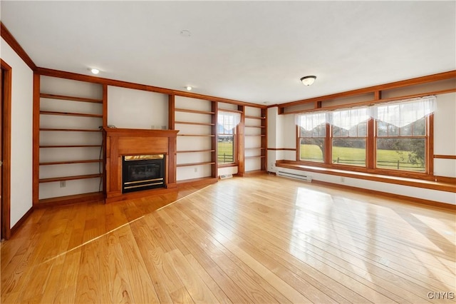 unfurnished living room featuring light hardwood / wood-style flooring and crown molding