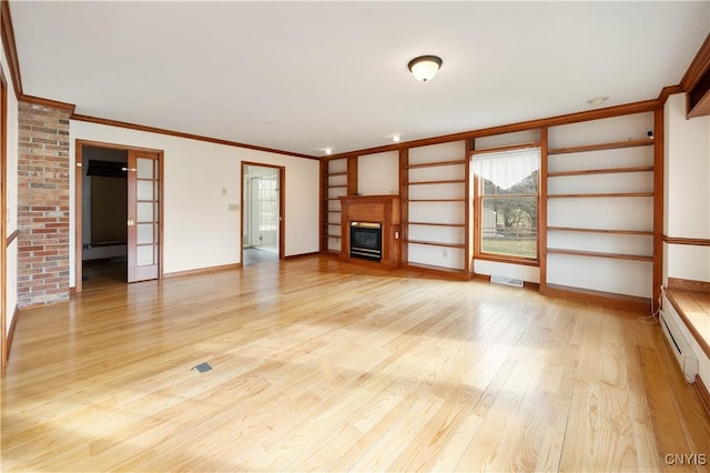 unfurnished living room with light wood-type flooring, a baseboard radiator, and crown molding