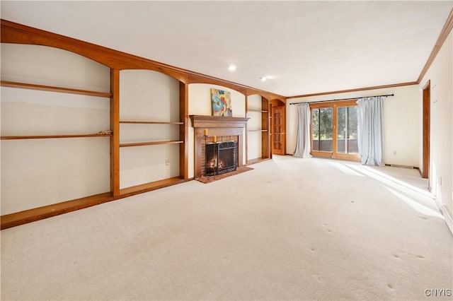 unfurnished living room with built in shelves, crown molding, and light carpet