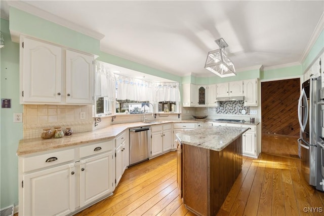 kitchen with light wood-type flooring, a center island, white cabinetry, and stainless steel dishwasher