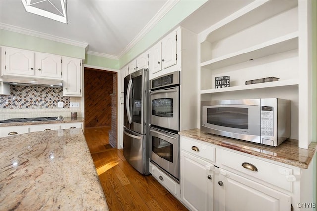 kitchen with light stone countertops, white cabinets, and stainless steel appliances