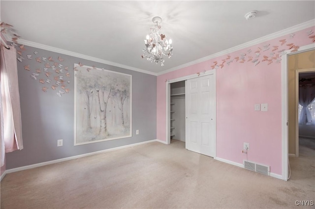 unfurnished bedroom with an inviting chandelier, light colored carpet, crown molding, and a closet