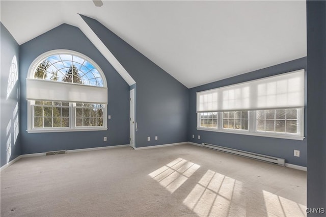 spare room featuring light carpet, lofted ceiling, and a baseboard heating unit