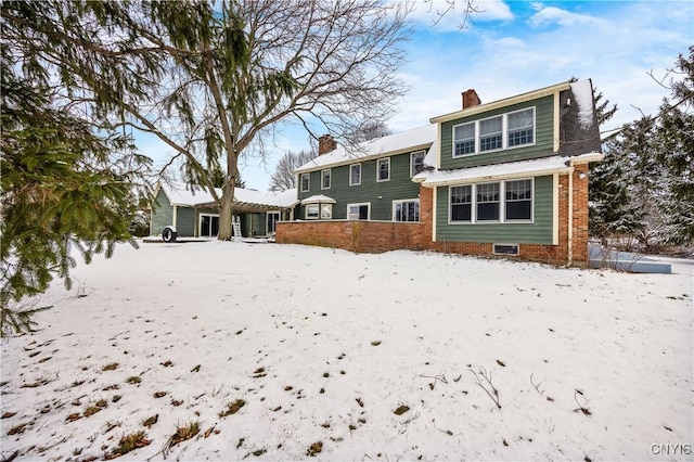 view of snow covered rear of property