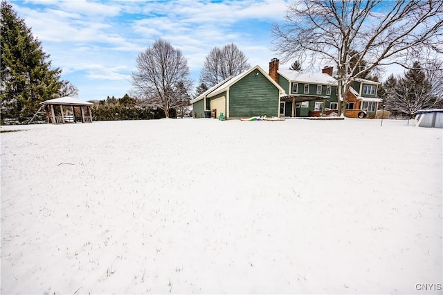 snowy yard featuring a gazebo