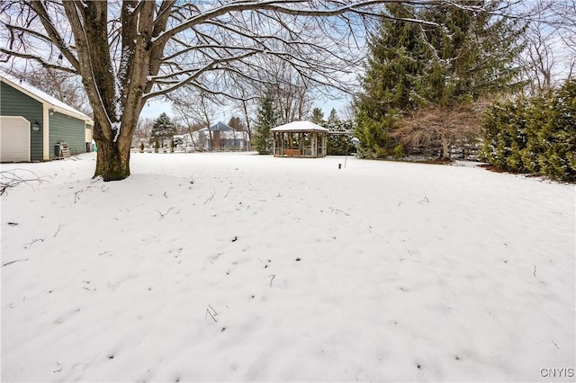 snowy yard with a gazebo