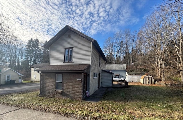 view of home's exterior featuring a yard and a storage shed