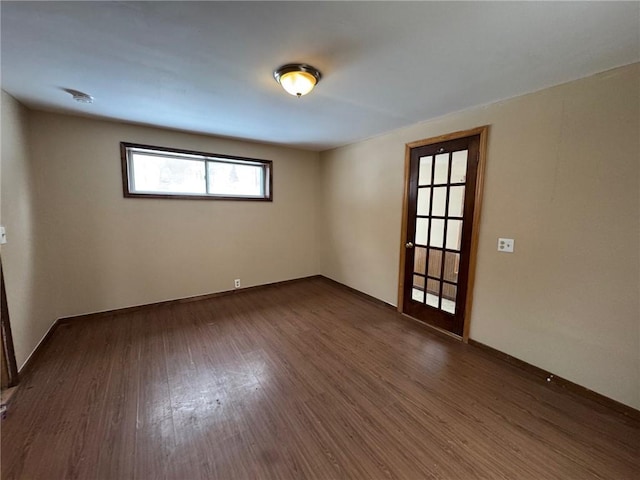 spare room with dark wood-type flooring