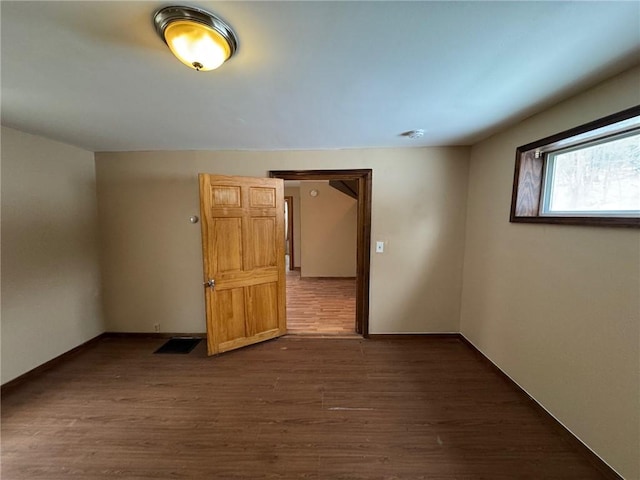 spare room featuring dark wood-type flooring