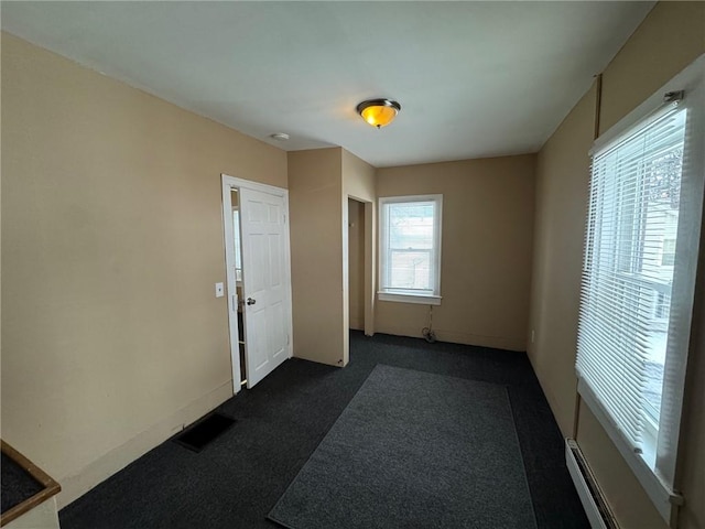 interior space featuring a baseboard heating unit