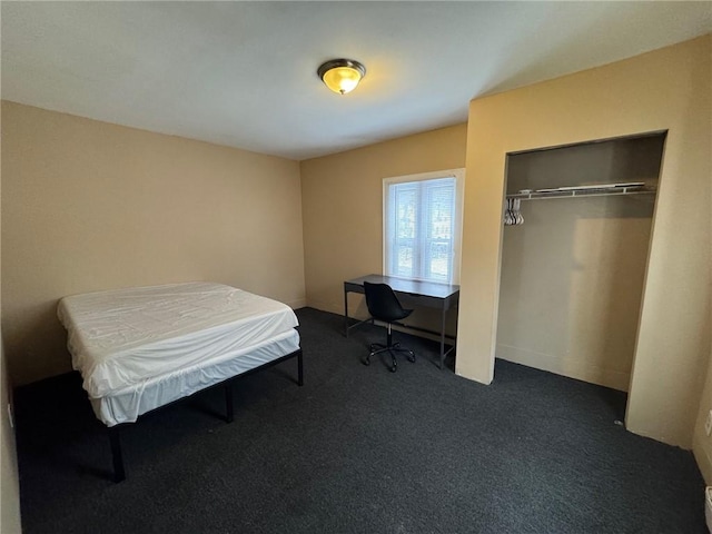 bedroom with a closet and dark colored carpet