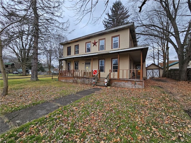 view of front of property featuring an outdoor structure and a porch