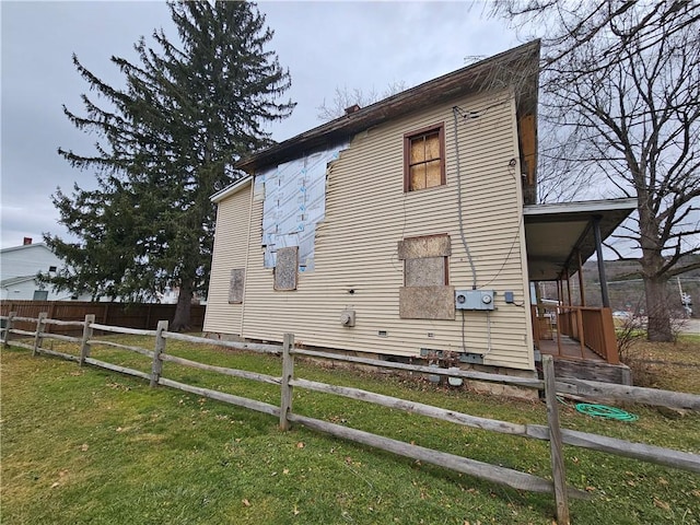 view of side of home with a lawn