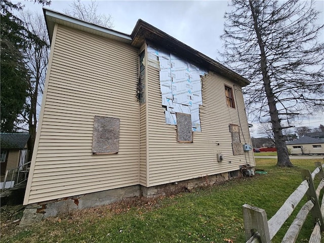 view of home's exterior with a yard