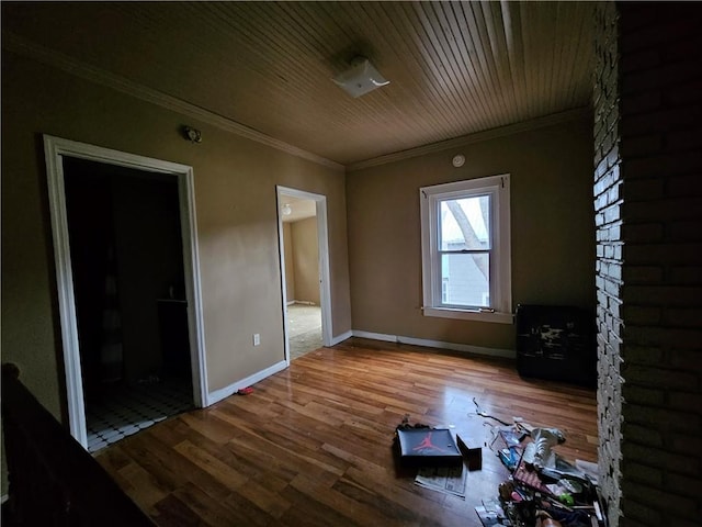 spare room featuring wood-type flooring and ornamental molding