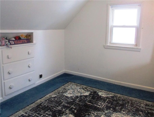 additional living space with carpet floors and vaulted ceiling