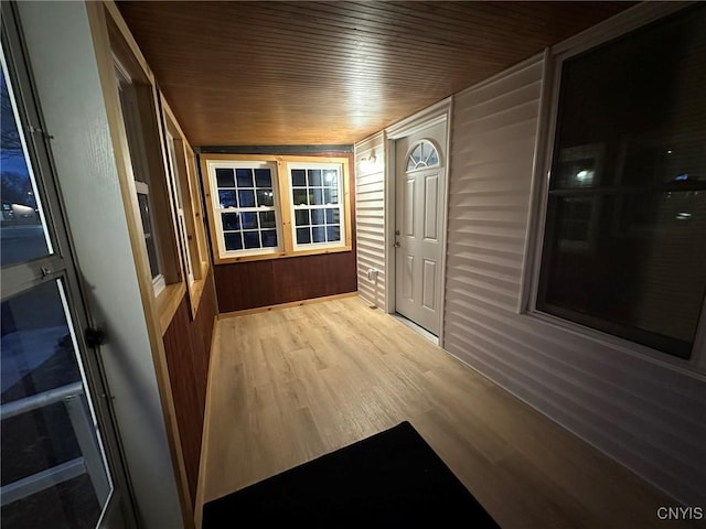 interior space featuring light hardwood / wood-style floors, wood walls, and wood ceiling