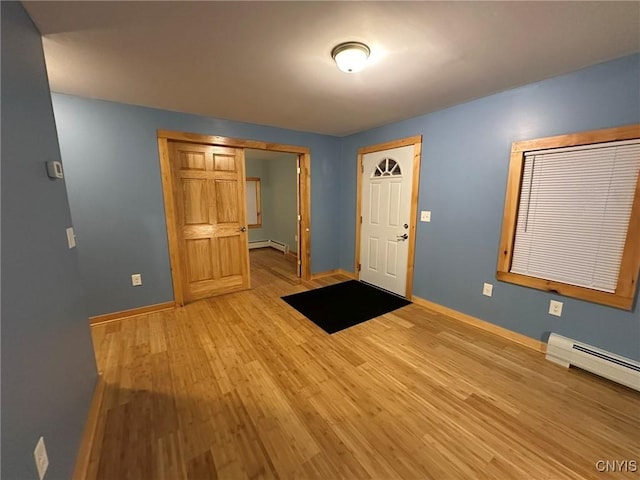 entrance foyer featuring light hardwood / wood-style floors and baseboard heating