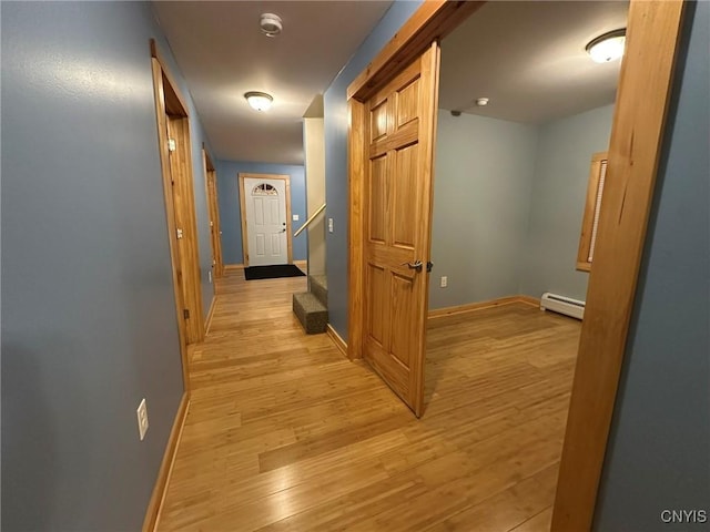 corridor featuring a baseboard radiator and light wood-type flooring