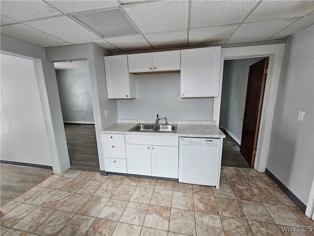 kitchen featuring white cabinets, a paneled ceiling, white dishwasher, and sink