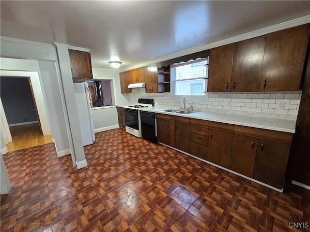 kitchen with freestanding refrigerator, a sink, gas range, dishwasher, and under cabinet range hood