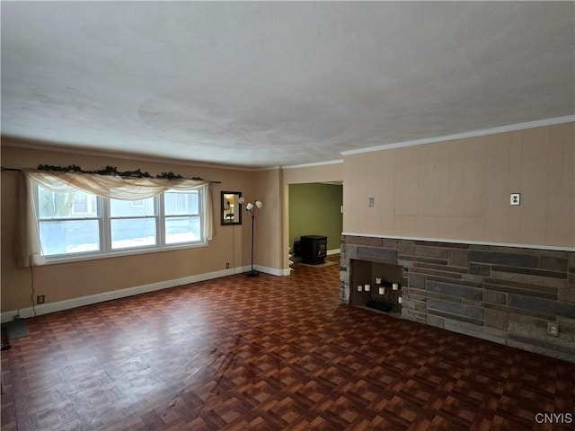 unfurnished living room featuring baseboards and crown molding