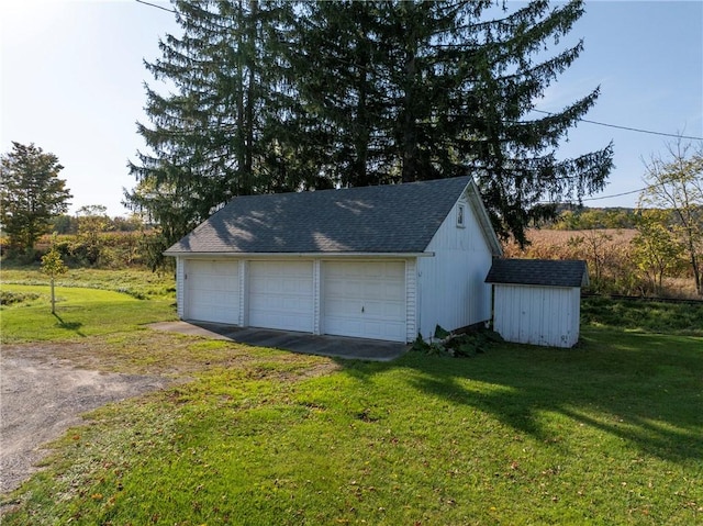 garage featuring a lawn