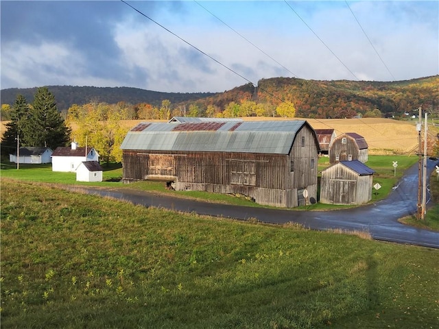 exterior space with a mountain view and a yard