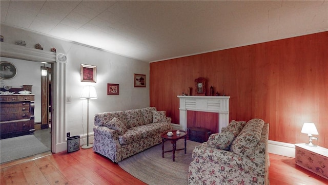 living room with a fireplace and light hardwood / wood-style flooring