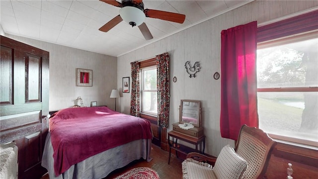 bedroom with ceiling fan and crown molding