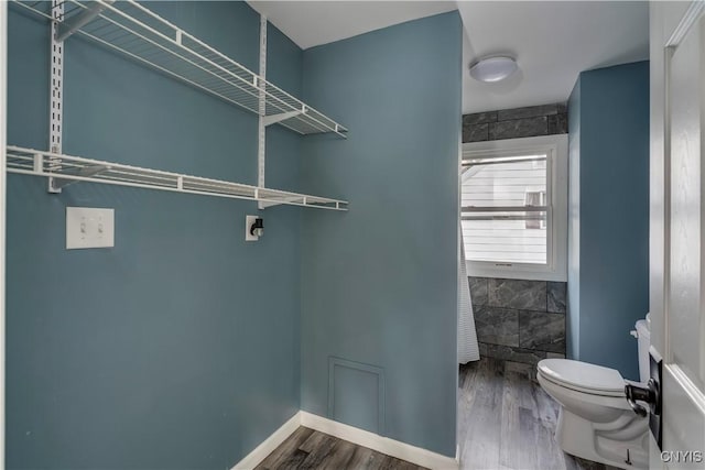 washroom featuring hardwood / wood-style floors and hookup for an electric dryer