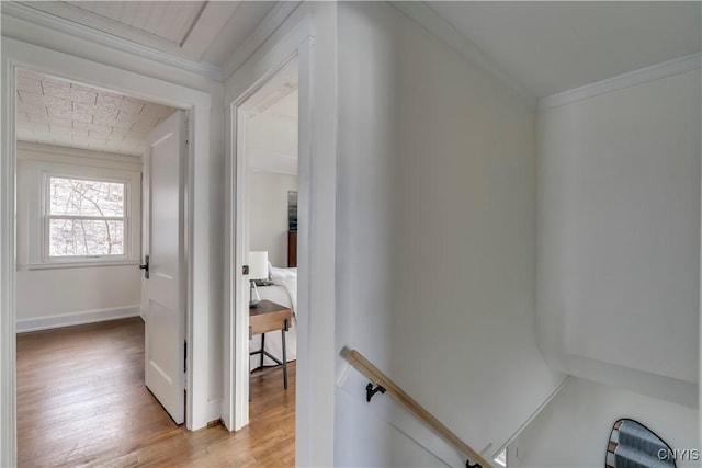 hall featuring light hardwood / wood-style floors and crown molding