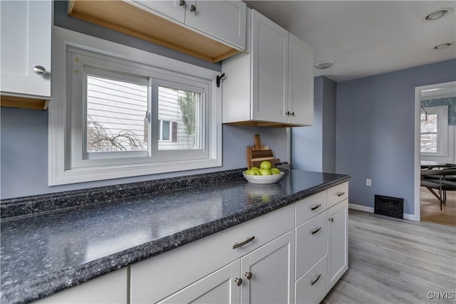 kitchen featuring plenty of natural light and white cabinetry