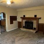 unfurnished living room with ceiling fan