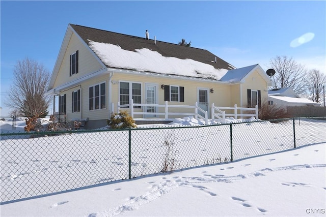 view of snow covered rear of property