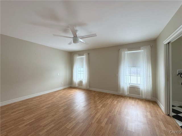 spare room with ceiling fan and light hardwood / wood-style floors