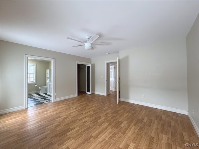 empty room with ceiling fan and light wood-type flooring