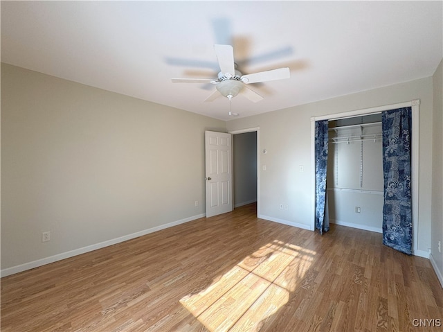 unfurnished bedroom with ceiling fan, light hardwood / wood-style floors, and a closet