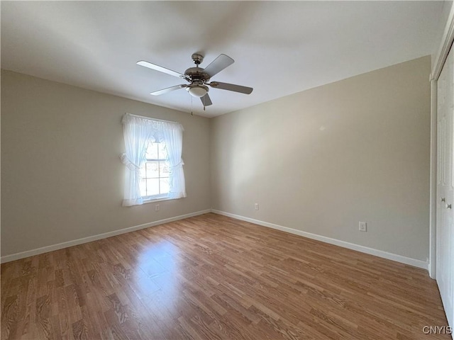 spare room with ceiling fan and hardwood / wood-style flooring