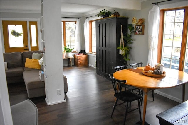 dining space with dark hardwood / wood-style flooring and ornamental molding