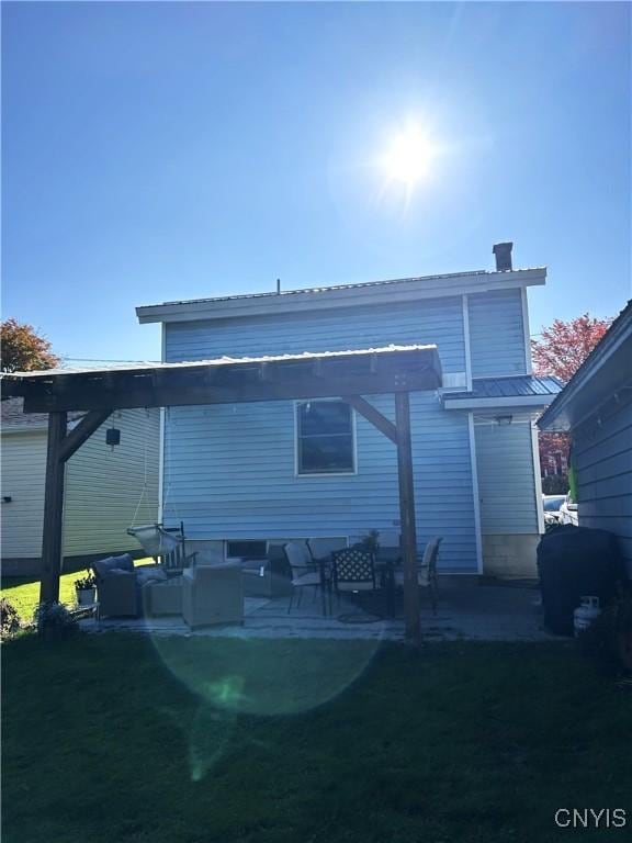 back of house featuring a lawn, a patio area, an outdoor living space, and a pergola